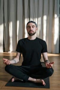 A man sitting on the floor meditating