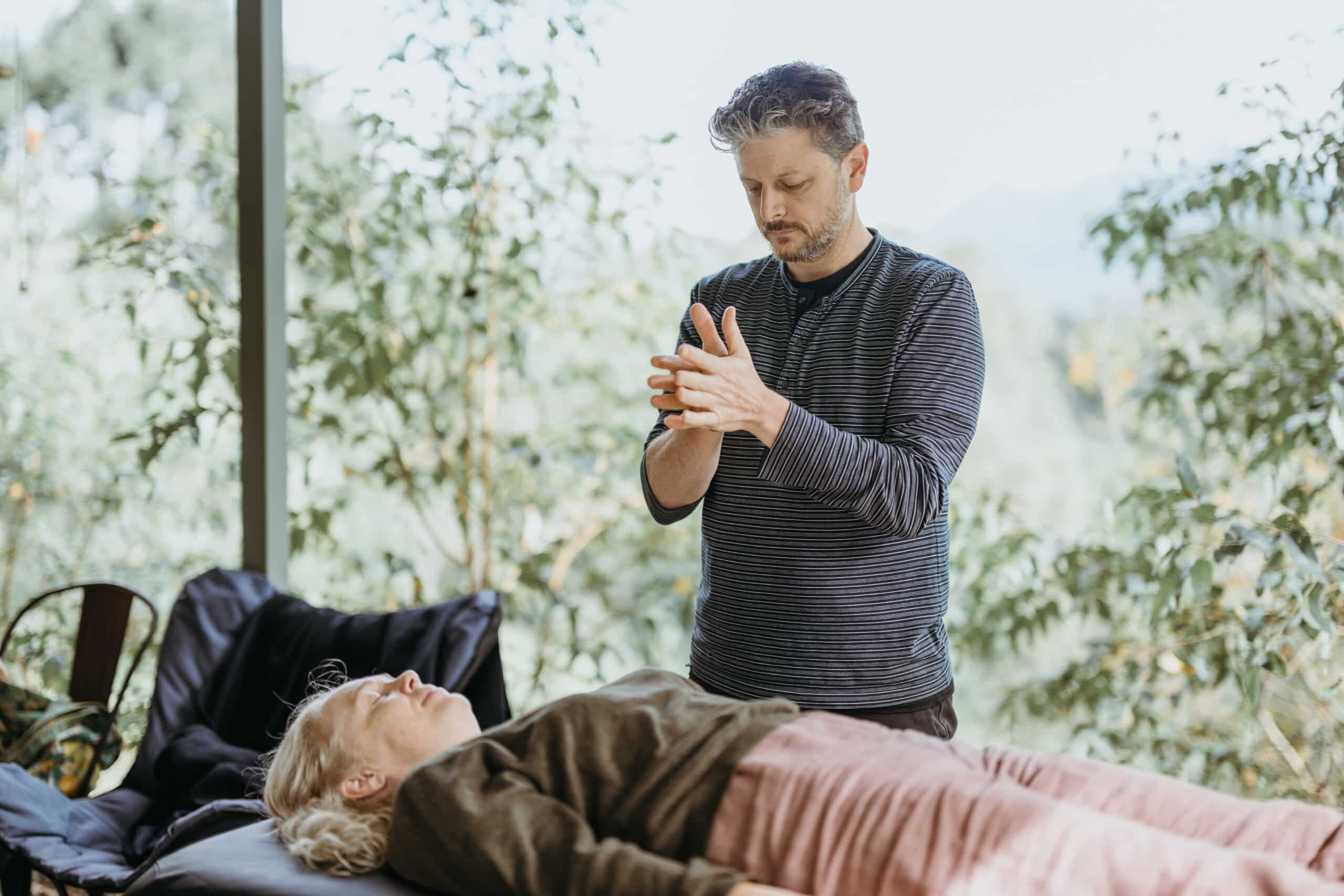 A student practicing marma on another retreat participants