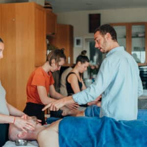 Dylan teaching a student during the Vital Veda Abhyanga course in 2023