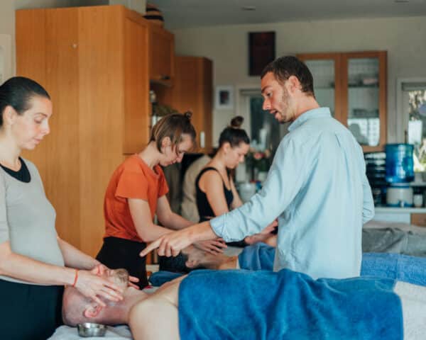 Dylan teaching a student during the Vital Veda Abhyanga course in 2023