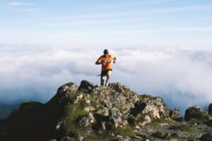 A man running on top of the rocky mountain