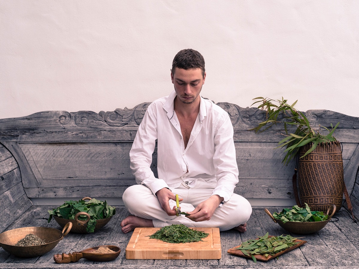 Preparing herbs for Pinda Sveda Patra Poultice bolus